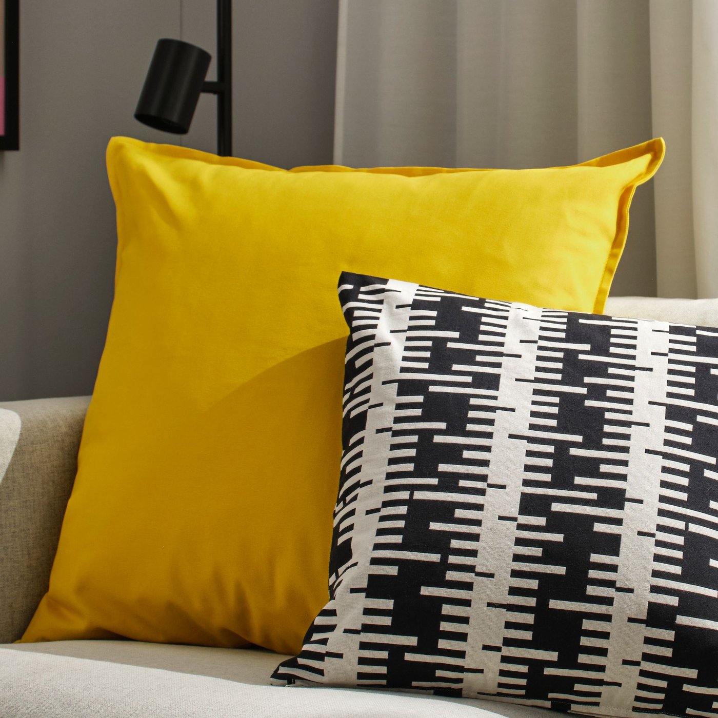 An off-white/black STOCKHOLM 2025 cushion cover