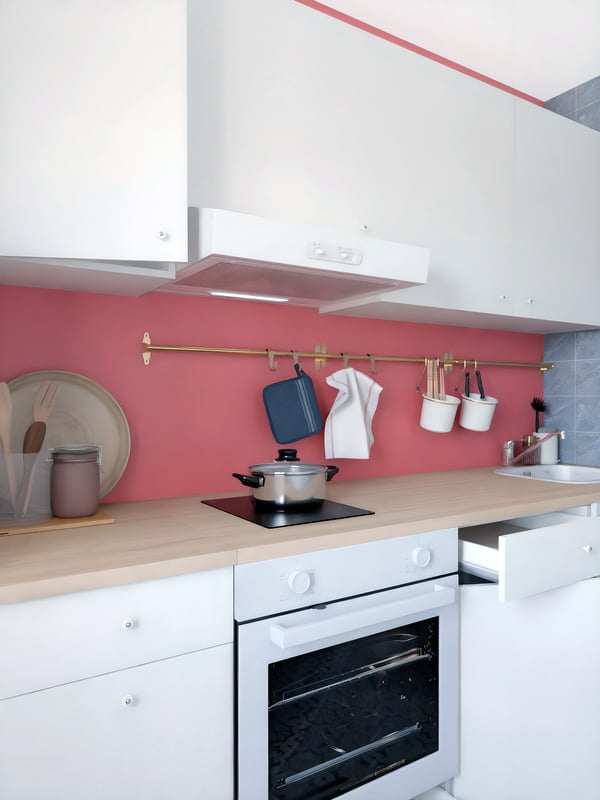 A white KNOXHULT kitchen with LAGAN appliances and a pink feature wall