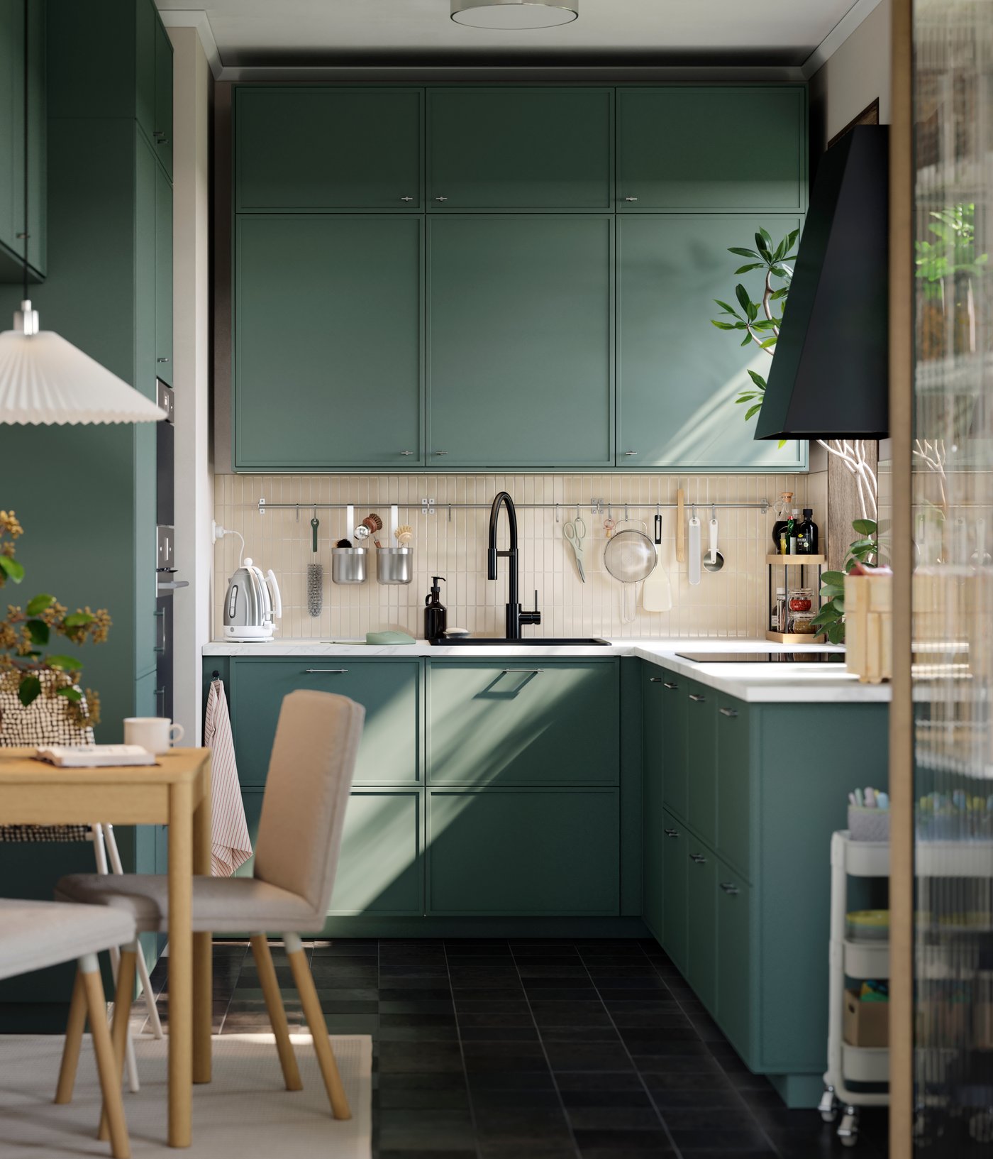 A small kitchen has base, wall and top cabinets, going all the way to the ceiling and there’s a small table with a chair.