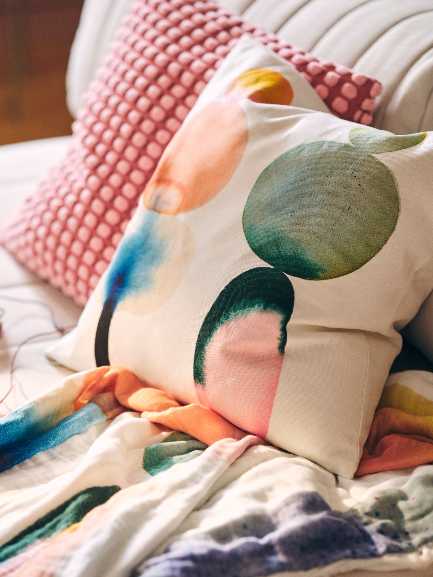A white/multicolour IKEA PS 2026 cushion cover in the NA