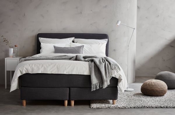 A white NORDLI bedside table in the bedroom