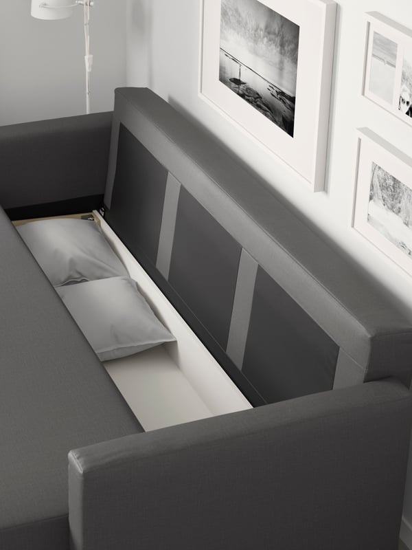 A Skiftebo dark grey FRIHETEN three-seat sofa-bed