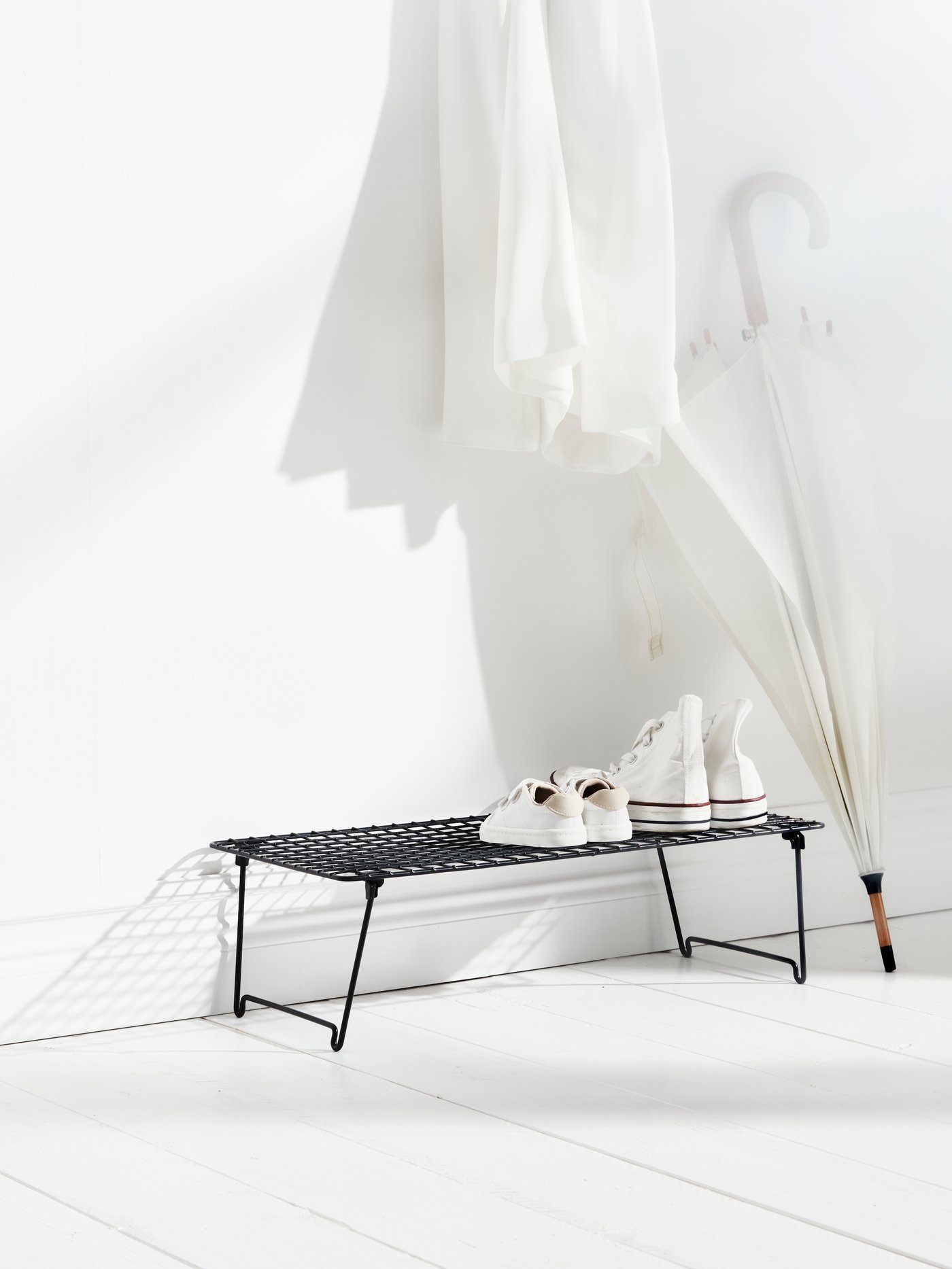 A grey GREJIG shoe rack in the hallway