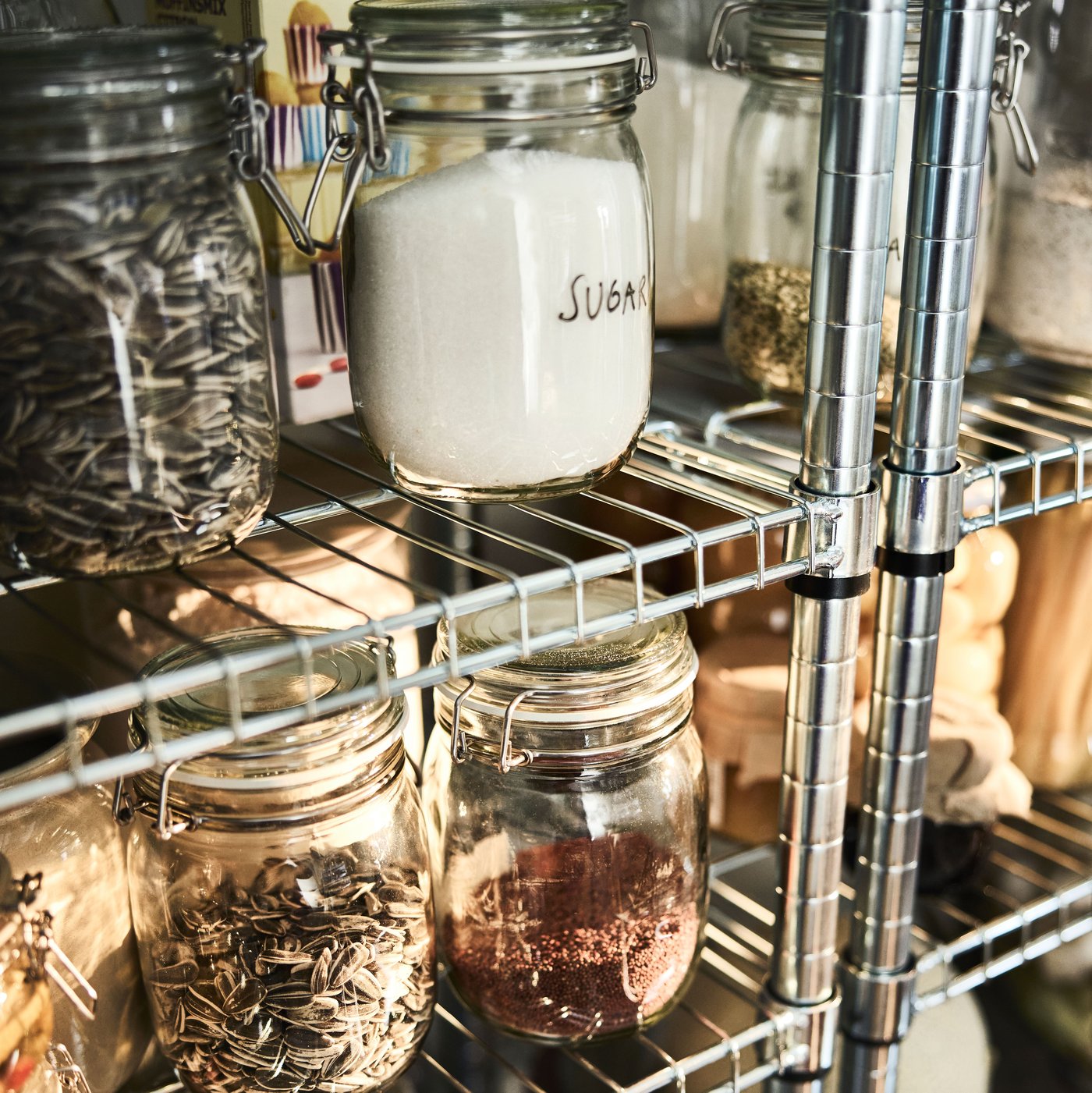 OMAR shelving units store and organise dry food for an open pantry.