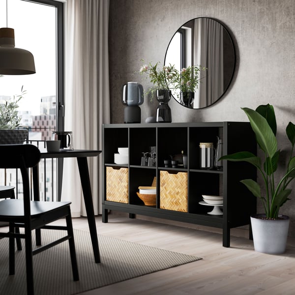A black-brown/black KALLAX shelving unit with underframe in the dining room