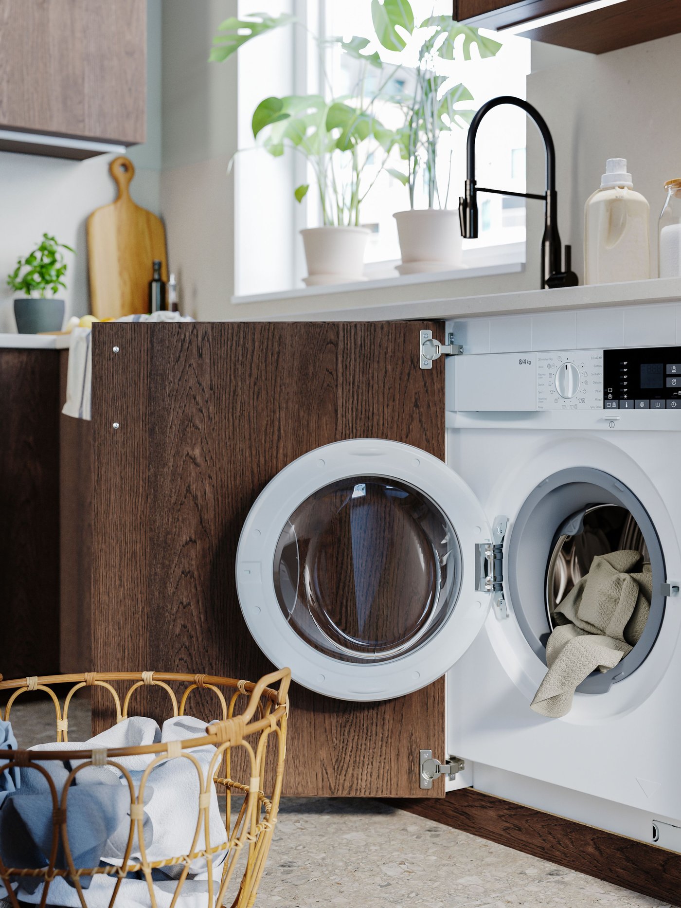 An integrated washing machine open under the kitchen counter