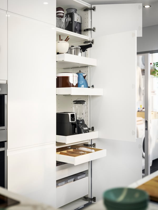 A kitchen cupboard featuring MAXIMERA drawers, storing appliances like a blender, air fryer, and utensils neatly organised.