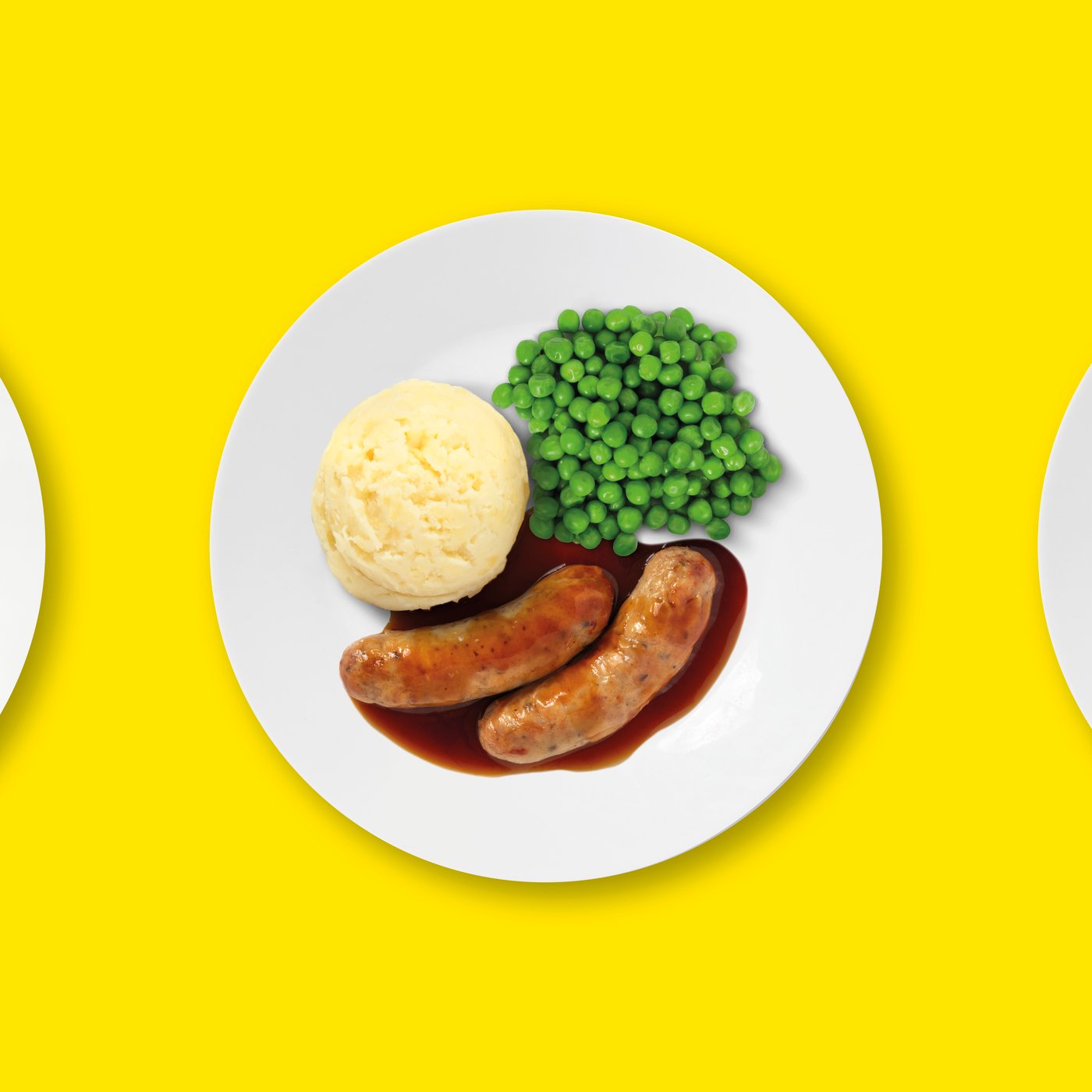 Sausage with mash on a white plate on a yellow background
