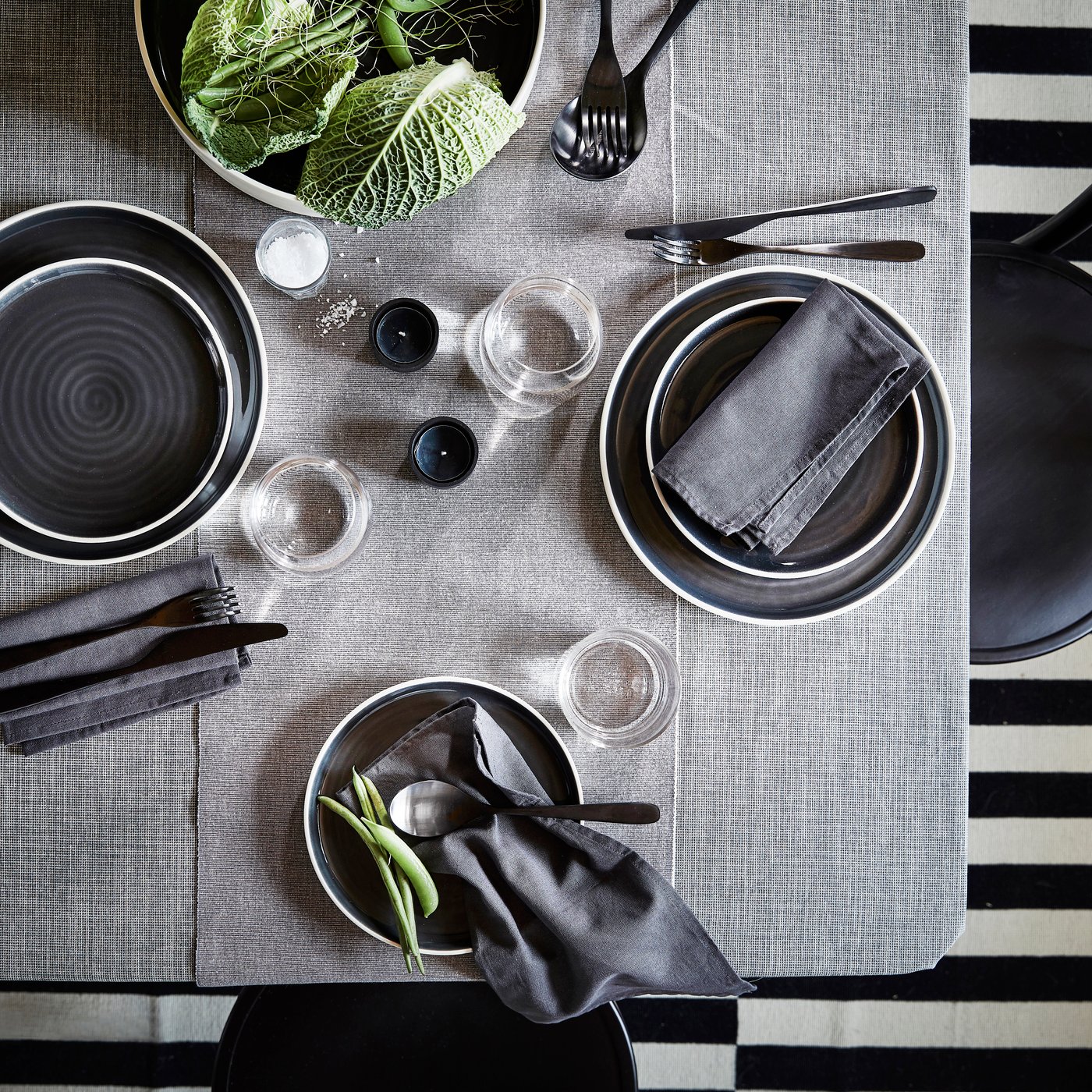 A dark grey SVARTSENAP napkin