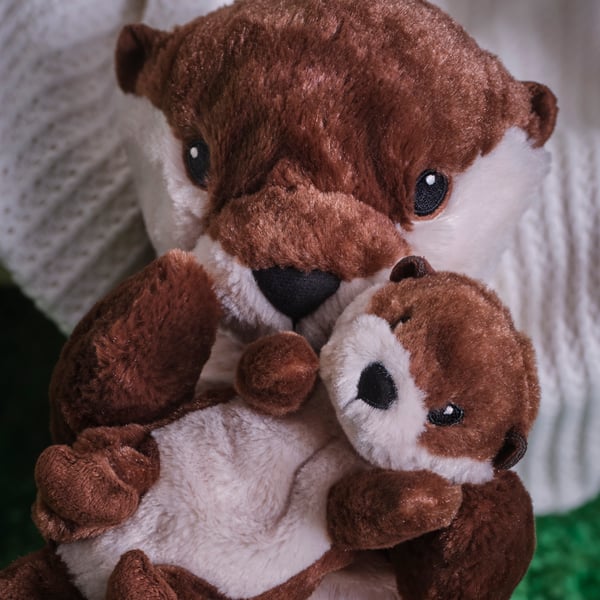 An otter with baby/brown beige SKOGSDUVA soft toy
