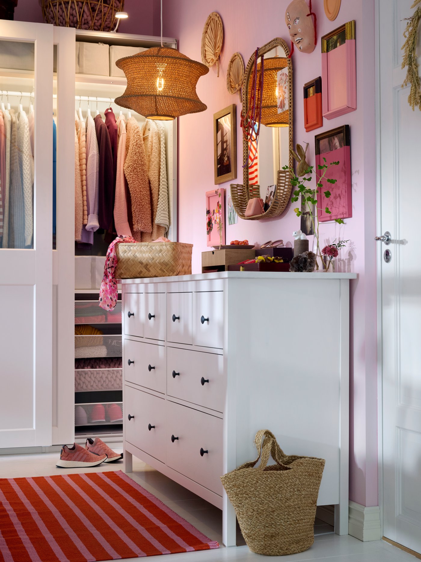 White HEMNES chest of drawers along wall to the right, PAX/GRIMO wardrobe in back, lots of art and mirrors on the wall.