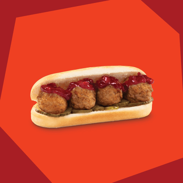 Meatballs in a bun on a red background.