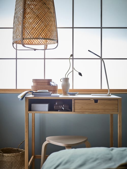 Workspace with dressing table used as a desk, stool, pendant lamp, work lamp, basket, vase, plants, agendas, boxes with lids.