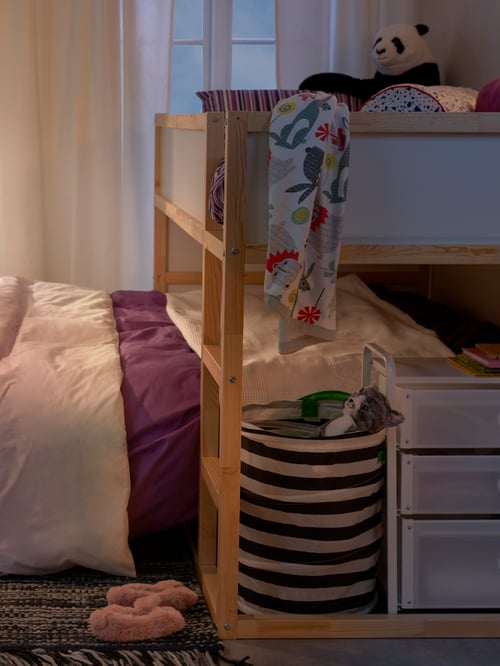 Bedroom with bed frame, reversible bed frame, quilt cover, pillowcases, soft toy, rug, slippers, laundry basket, storage unit.