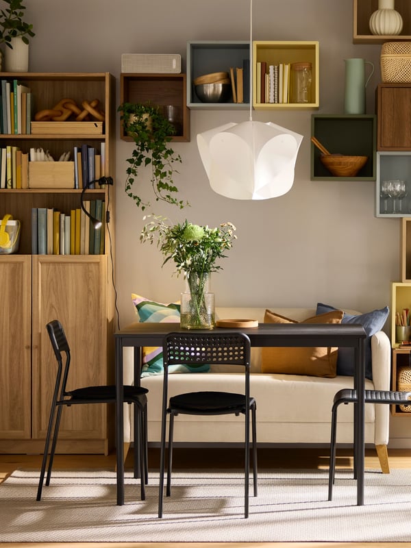 A light grey-blue EKET cabinet in the dining room