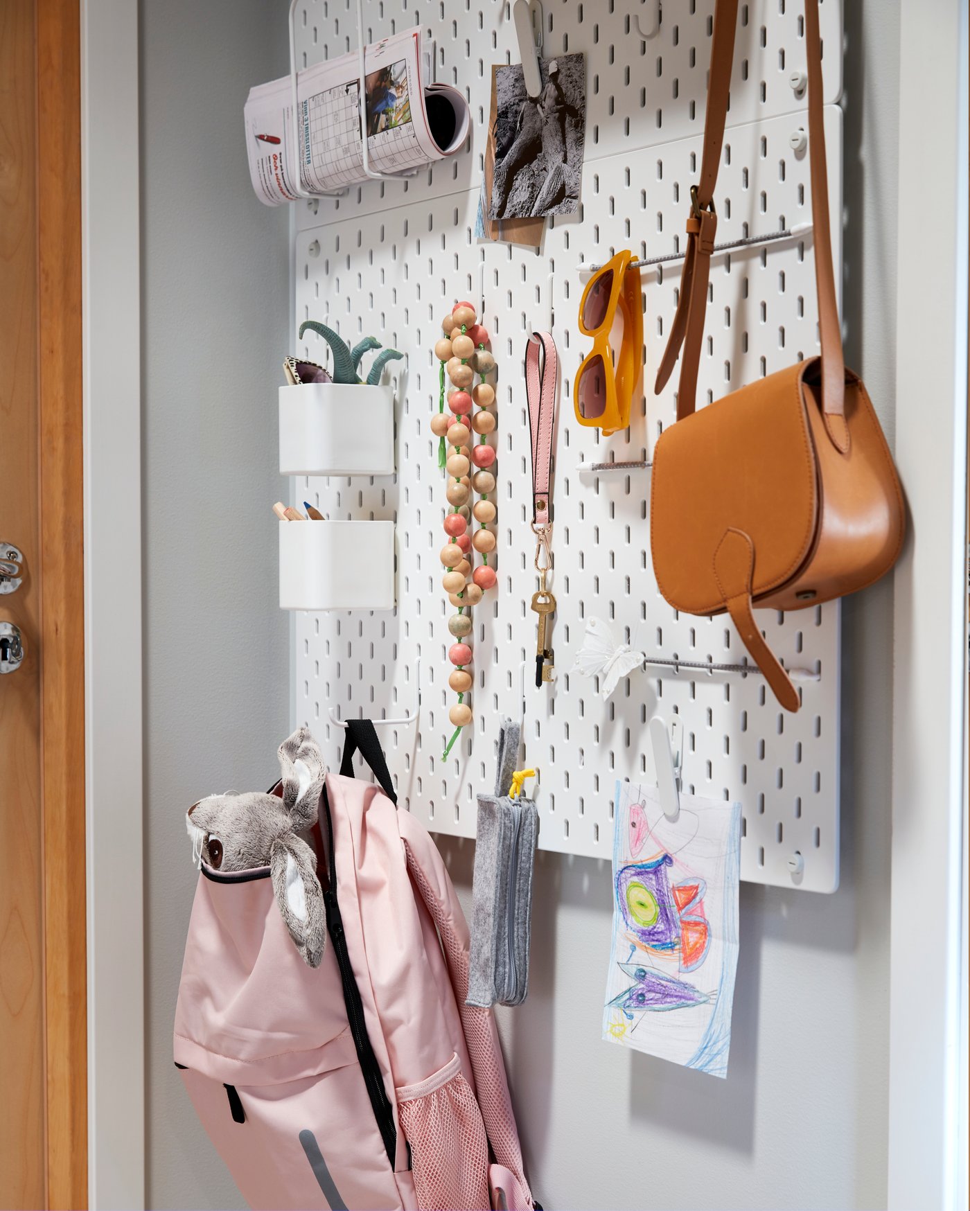 A white SKÅDIS container in the hallway
