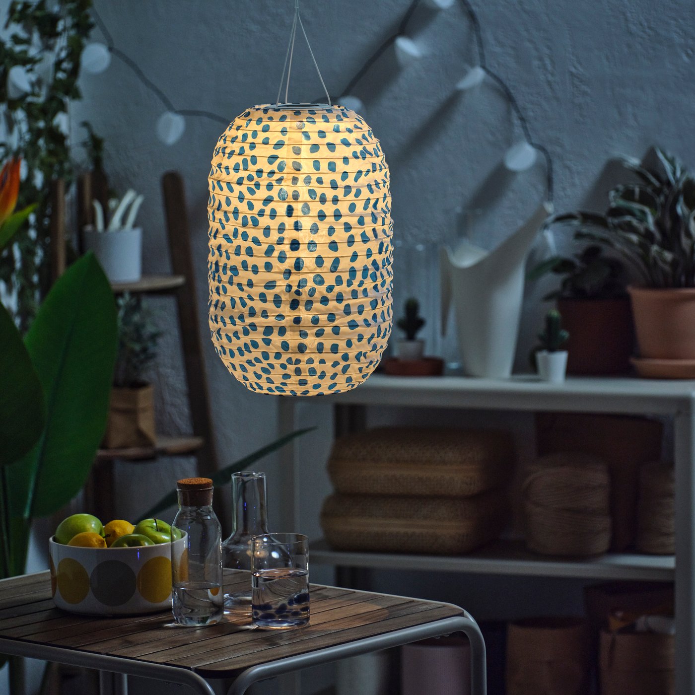 A spotted solar-powered/blue SOLVINDEN pendant lamp