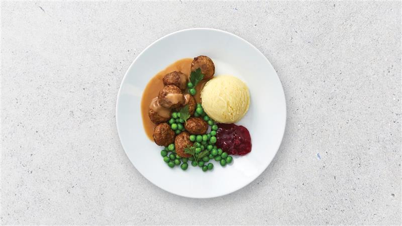 Meatballs, peas and mash potato on a plate