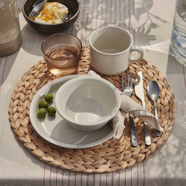 A stripe pattern red/natural VIPPSTARR tablecloth outside