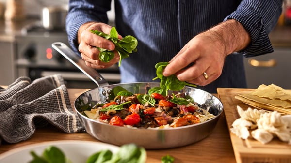 A stainless steel HEMKOMST frying pan