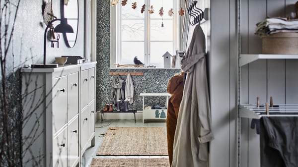 Light grey hallway with hanging jackets.