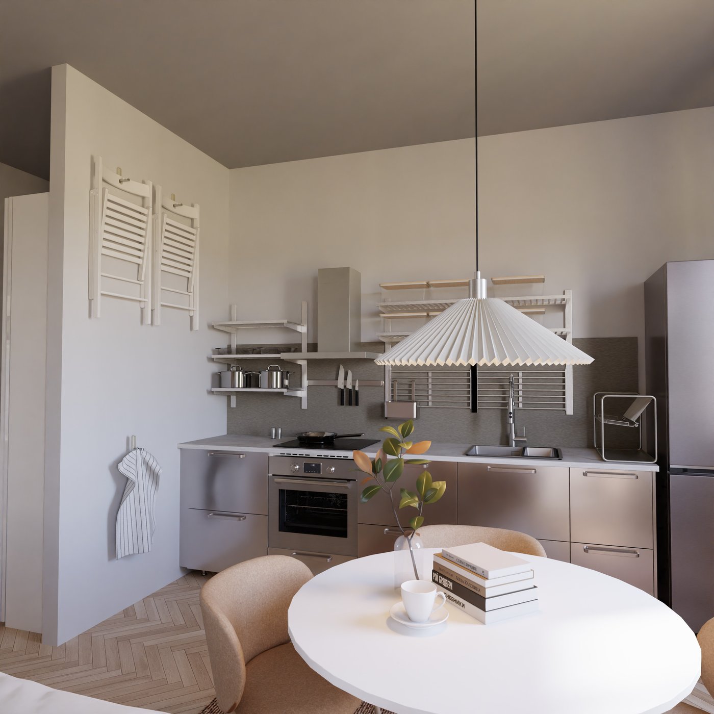 Edelstahlküche mit rundem Esstisch davor.