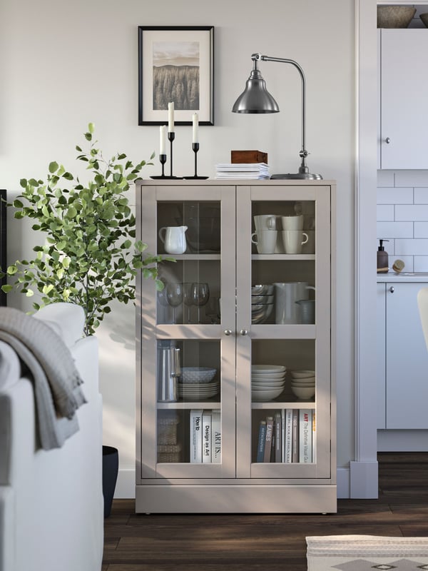 A grey-beige/clear glass HAVSTA glass-door cabinet with plinth