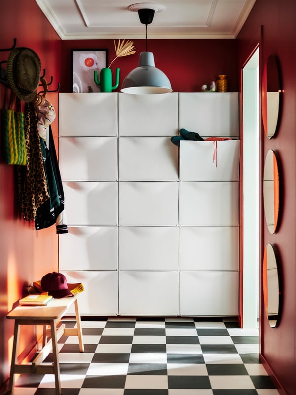 A white TRONES shoe cabinet/storage in the hallway