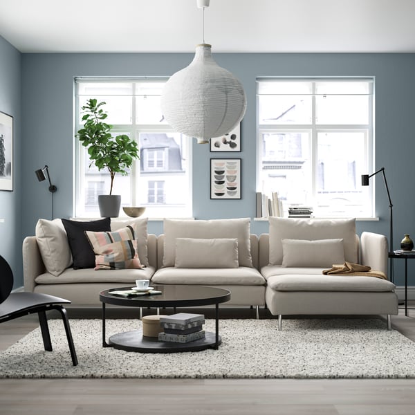 A Fridtuna light beige IKEA SÖDERHAMN 4 seater modular sofa with chaise longue in a dusty blue room