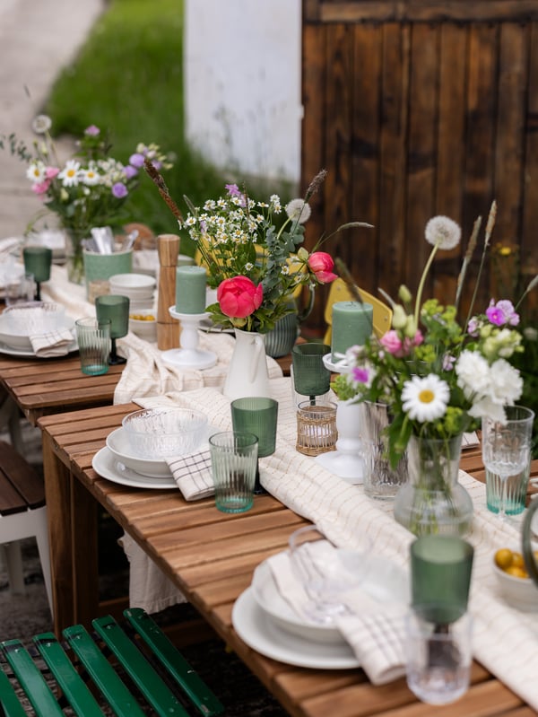 A midsummer table laid out in the countryside.