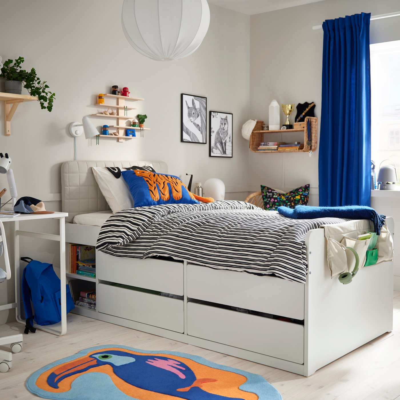 A white SLÄKT bed frame with storage