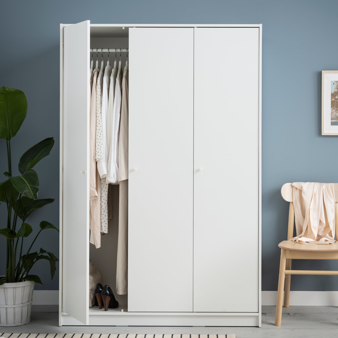 A white KLEPPSTAD wardrobe with 3 doors in the bedroom