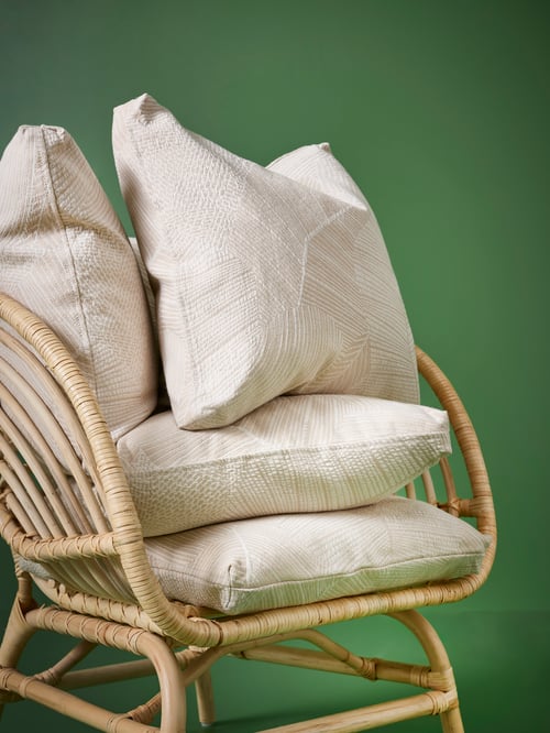 Outdoor featuring multiple square JÄTTEGRAN cushion covers placed on a BUSKBO armchair made of rattan.