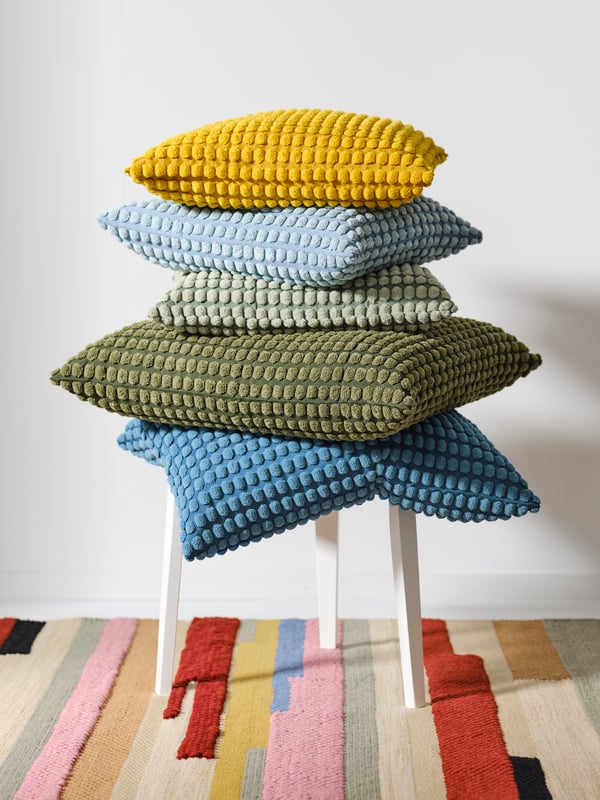 A pale blue SVARTPOPPEL cushion cover