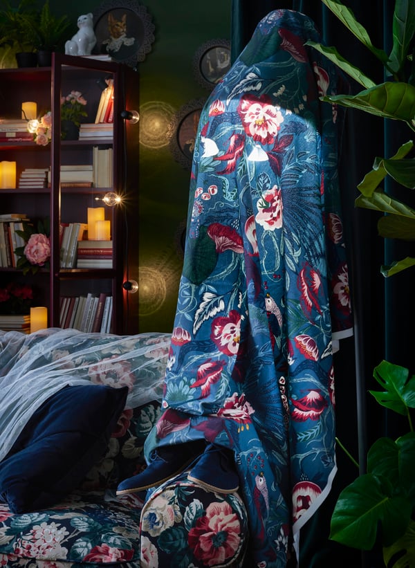 Add a warm glow and ghost-like effect by draping a coordinating textile over a floor lamp.