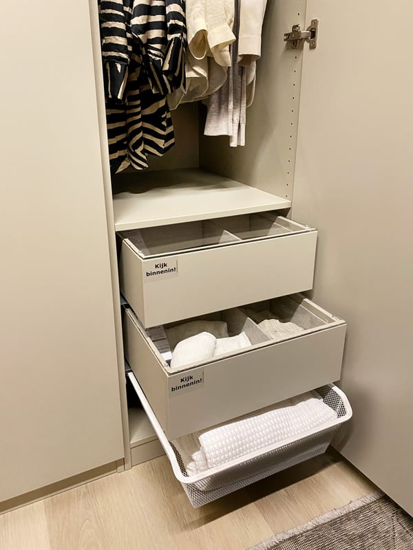 Open drawers in a beige PAX closet