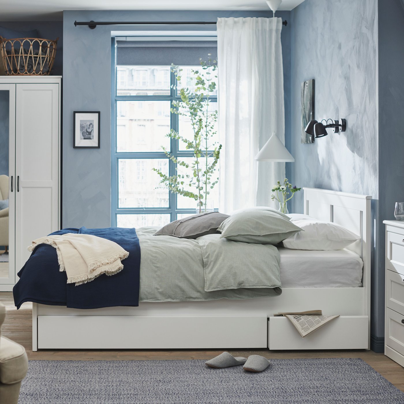 A black SKURUP wall lamp in the bedroom