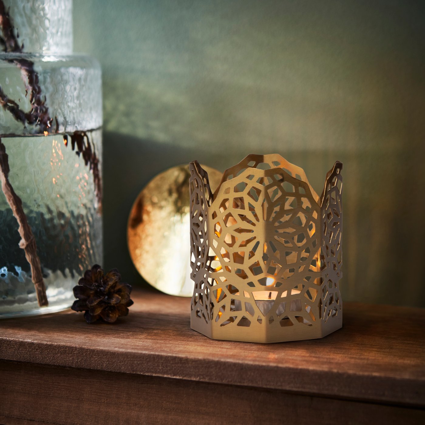 A gold-colour GOKVÄLLÅ tealight holder