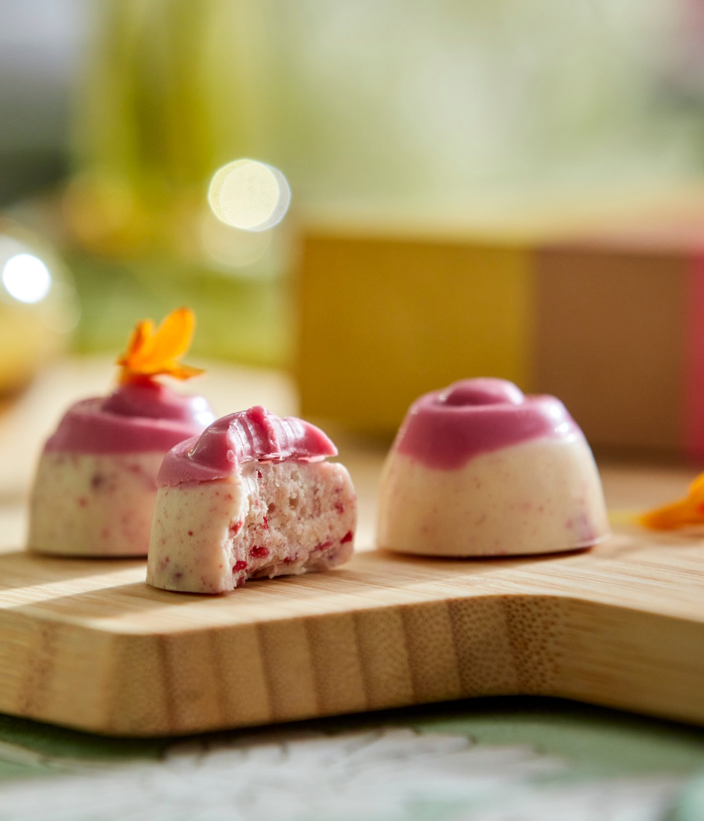 A close-up of some VÅRKÄNSLA raspberry cheesecake flavoured chocolate pralines.