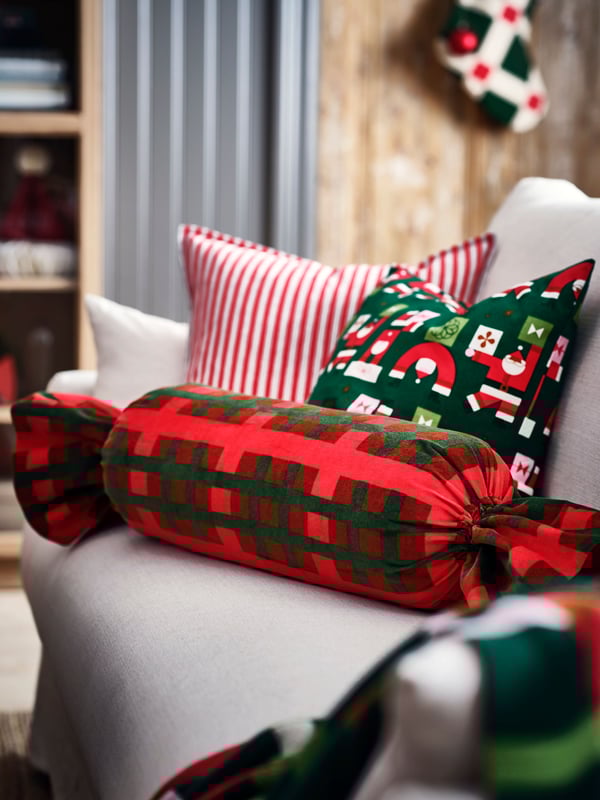 A striped red/white VINTERFINT cushion cover in the NA