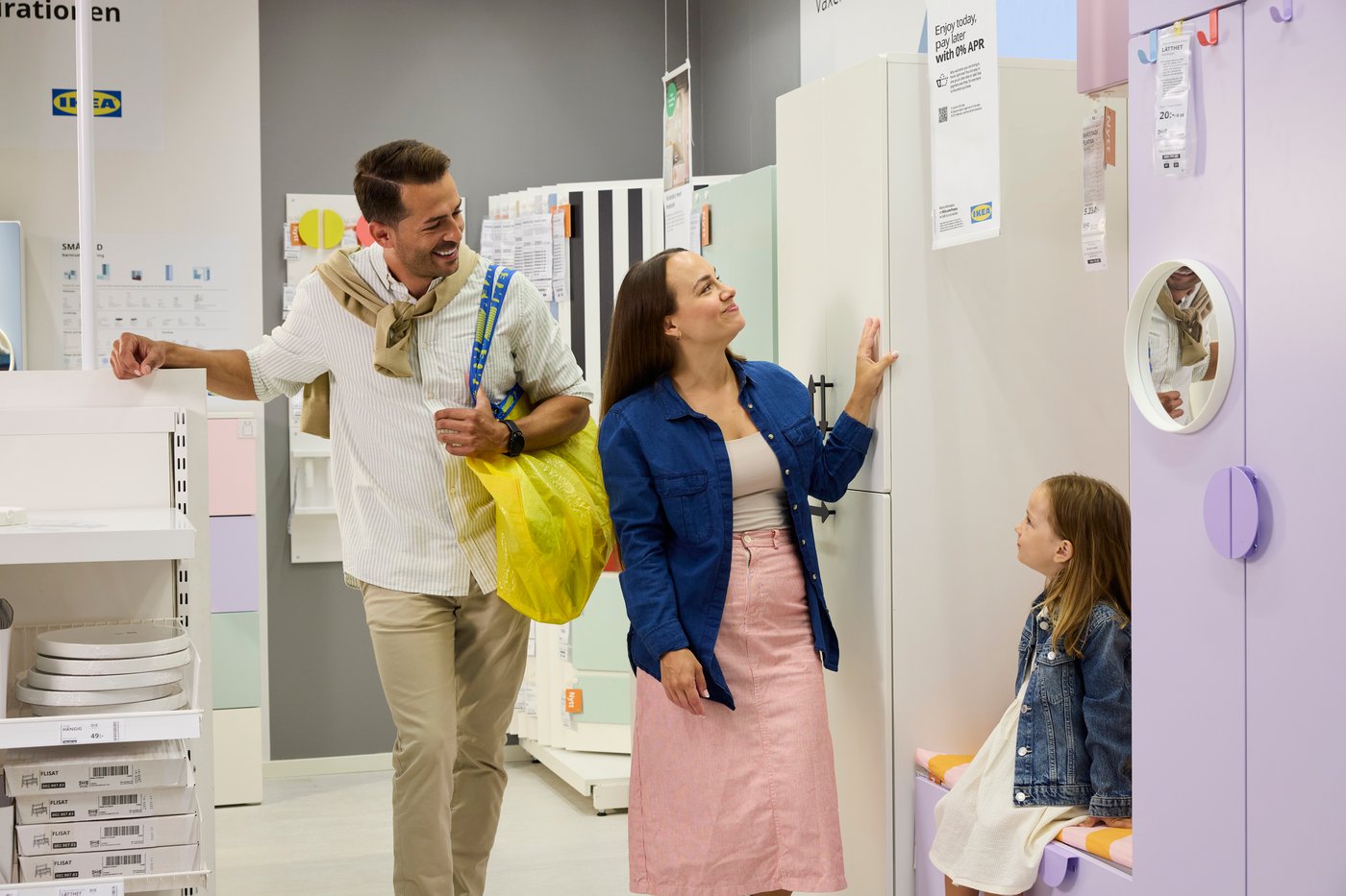 A father, mother and child shopping for children's wardrobes