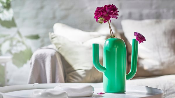 A bright green ÄRTBUSKE vase/watering can