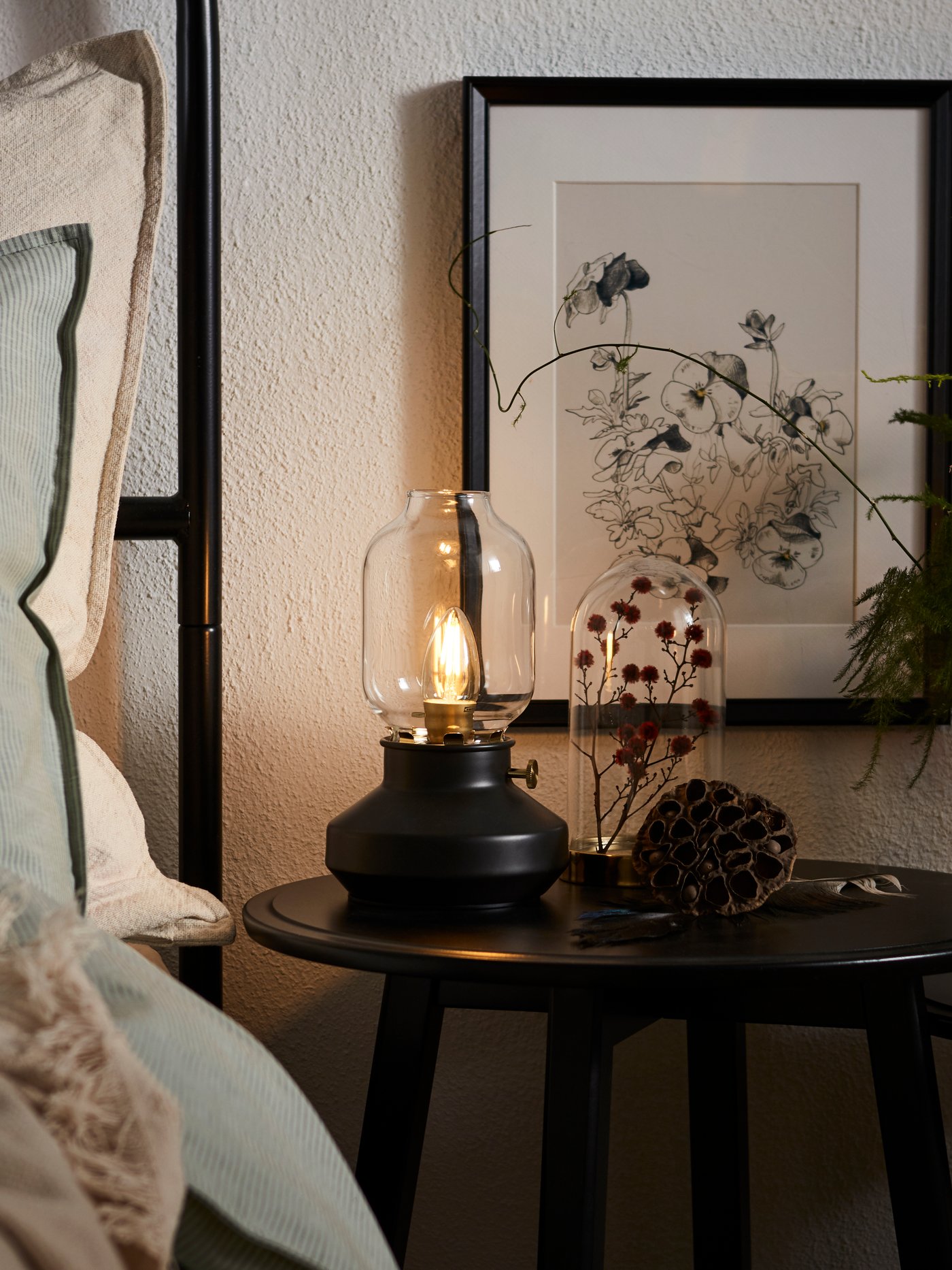 A black KRAGSTA nest of tables in the bedroom