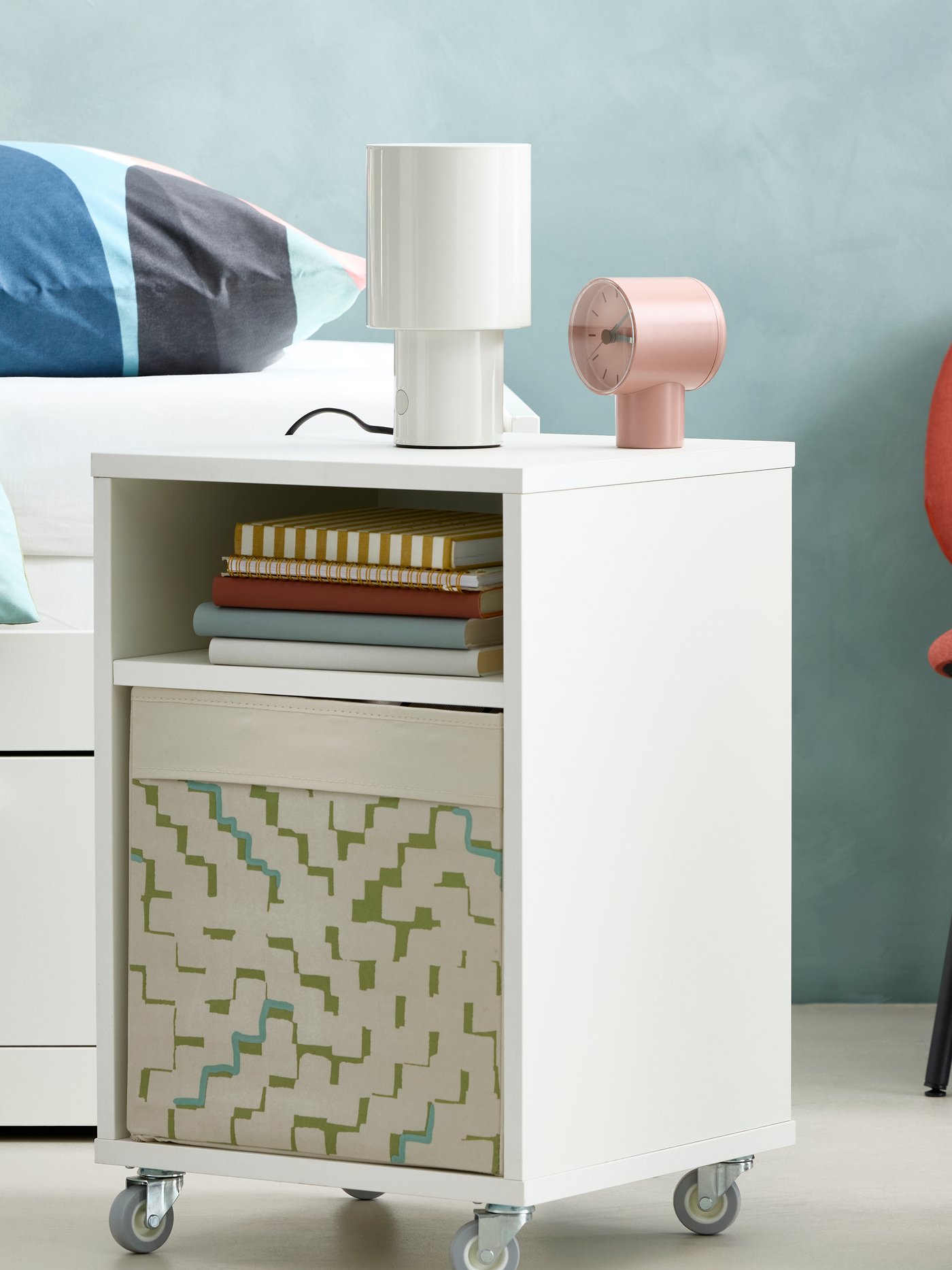 Close up of BRIMNES day-bed with SVALSTJÄRTAR duvet cover and OLIVSPINNMAL throw. VIHALS bedside table, GÄVLE chair beside.