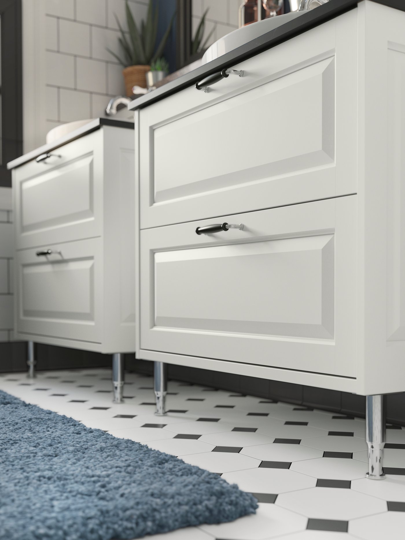 A stainless steel/shiny ALMAÅN leg in the bathroom