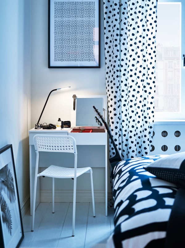 A white ADDE chair in the bedroom