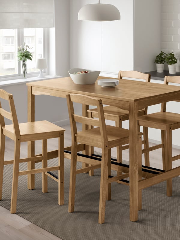 An antique stain pine HÄGERNÄS bar table and 4 bar stools