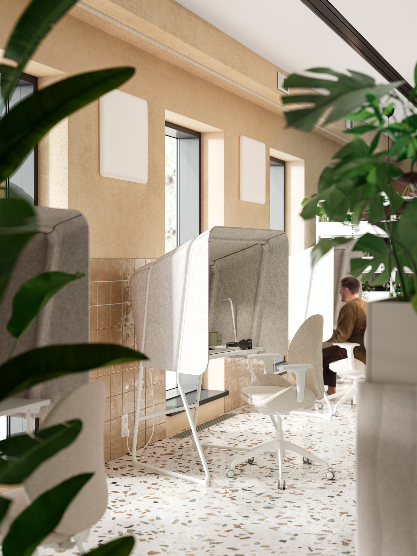 Three Gunnared beige/white MITTZON focus workstations, separated by windows in a wall, with their booth-like shells facing a lounge.