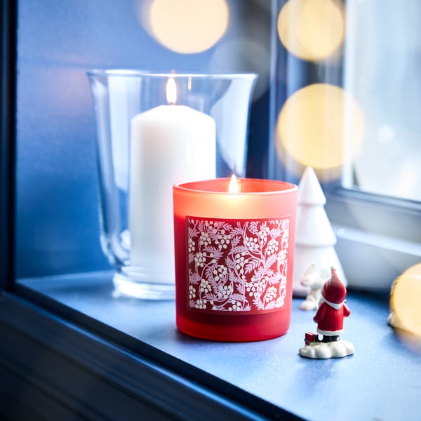 LED and classic flame candles by the window