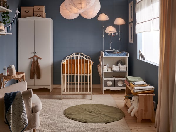 A kids bedroom with a blue wall